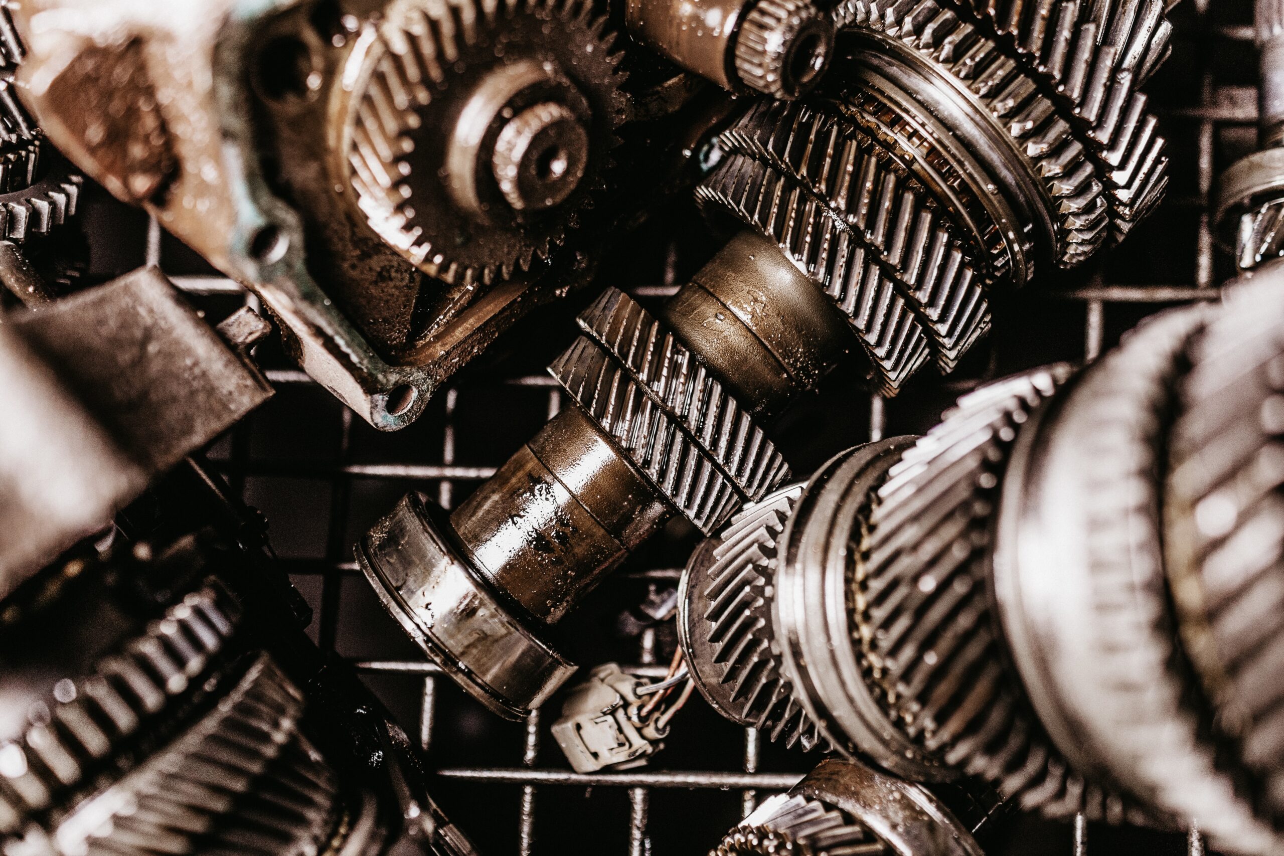 Closeup shot of dirty metal gears on a grid under light